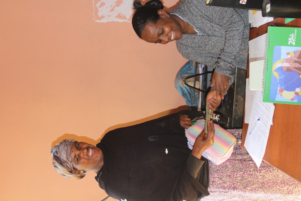 Children and caregivers waving together during a distribution day