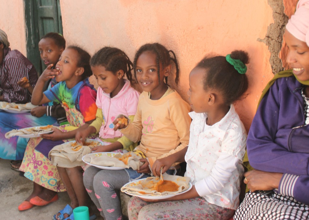 Volunteer serving food during Saturday feeding program