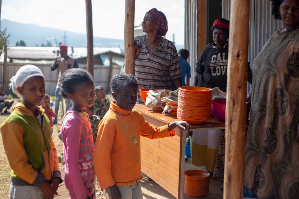 Child receiving a meal during Saturday feeding program